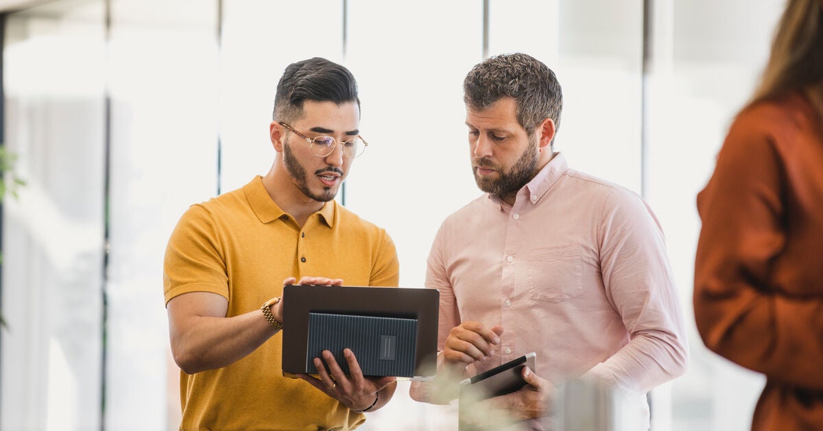 A man showing his colleague what do digital marketing agencies do