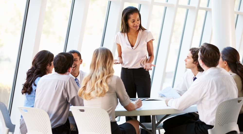 Group of colleagues discussing work at a meeting