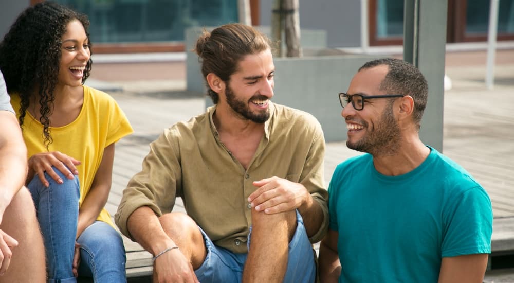 Laughing mix raced friends spending great time together outside. 