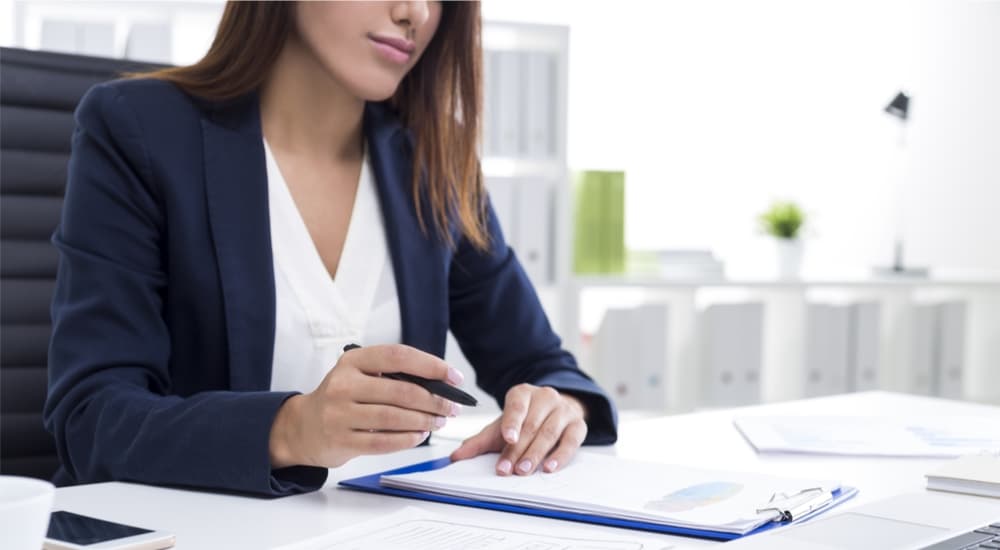 Business woman reviewing an employee complaint at her desk