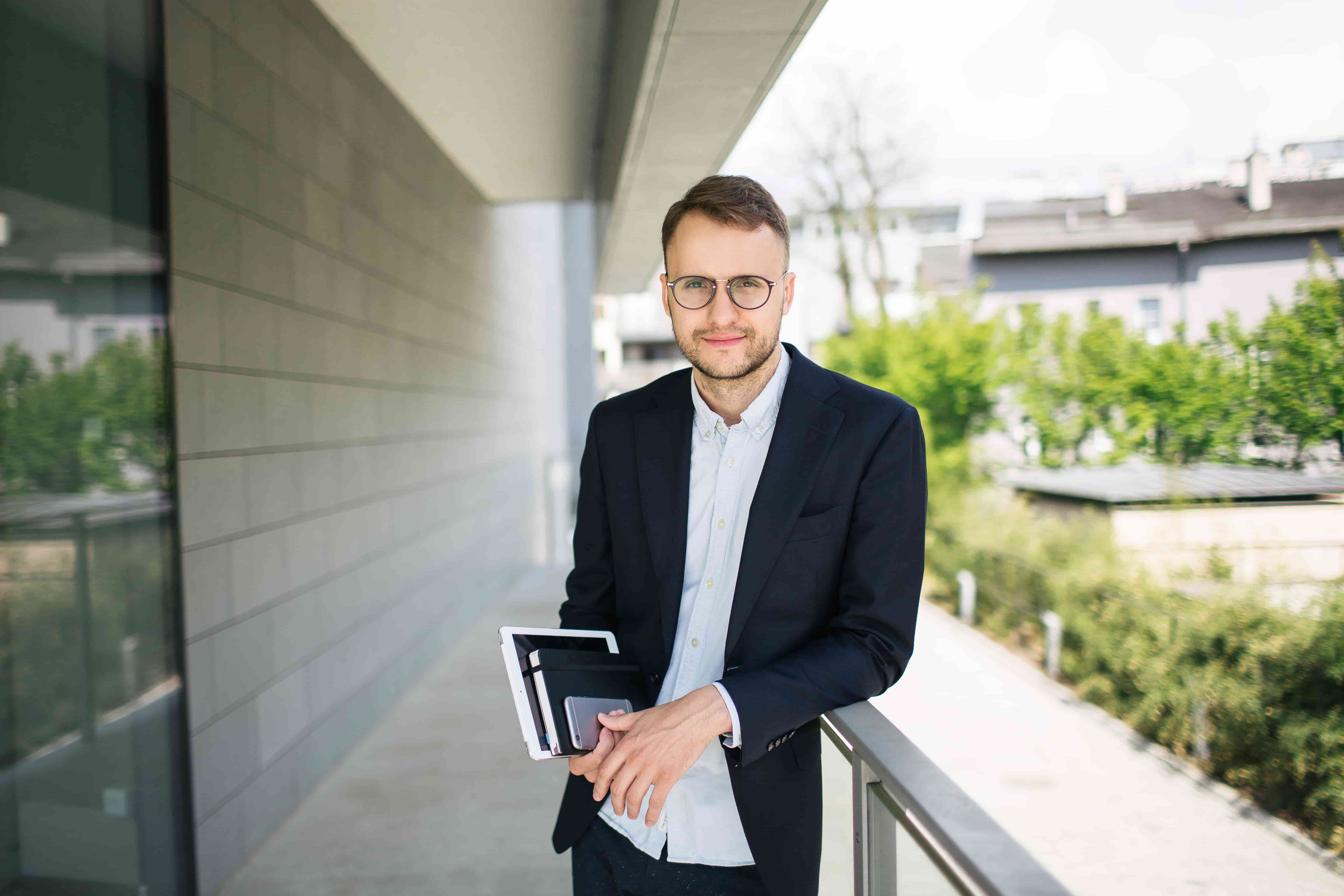 Marketer standing outside holding paperwork